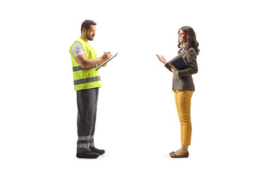 Full length profile shot of a road assistance agent writing a document and listening to a young woman