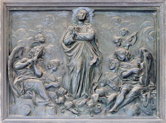 NAPLES, ITALY - APRIL 22, 2023:  The bronze relief of Assumption on the gate of church Basilica...