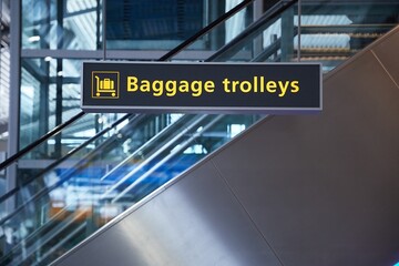 Airport terminal signs, luggage trolleys
