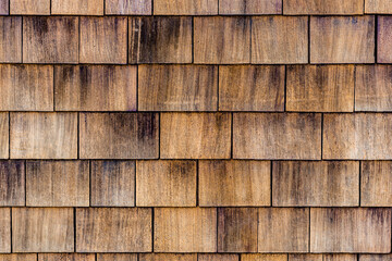 Grunge vintage looking wood texture abstract perfect for designers to use with copyspace and great tones. Several wood cedar shingles for siding or roofs. Cedar wood shingles up-close. Wood shake.