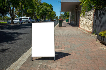 Background texture of a blank white advertisement board on walkway. Mockup template of a standing...