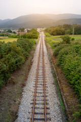 Fototapeta na wymiar Railway, Railroad, Train Tracks, Green Pasture, Mountain on Background
