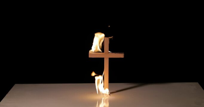 Fire around a burning cross symbol lighting up