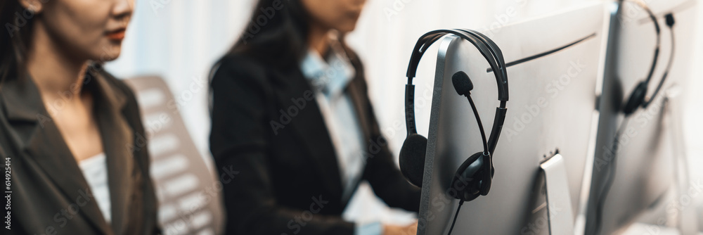 Aufkleber panorama focus headset on call center workspace desk with blur background of operator team or telesa