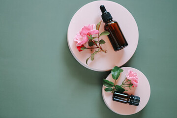  rose extract.Rose oil in a glass bottle on a gray background. View from above .Aromatherapy and...