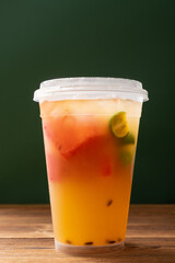 angle view cup of iced fruit drink at vertical composition