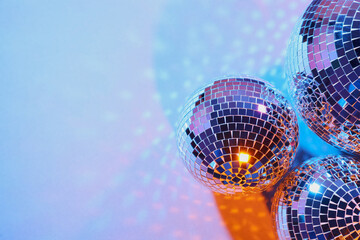 Bright shiny disco balls on color background, above view. Space for text