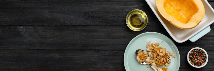 Raw spaghetti squash half in baking dish with seeds and spices on dark wooden table, flat lay. Banner design with space for text