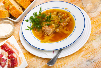 Traditional Russian dish is cabbage soup cooked in meat broth based on sauerkraut