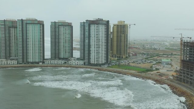 Aerial View Of Emaar Construction Works With Approaching Cyclone Biparjoy In Karachi. Circle Dolly