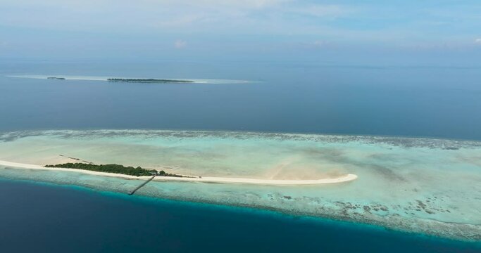 Aerial view of tropical island on the atoll and coral reef. Timba Timba islet. Tun Sakaran Marine Park. Borneo, Sabah, Malaysia.