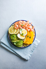 Buddha bowl with avocado, prawns, rice,  on light background. Healthy food, clean eating, Buddha bowl, top view,
