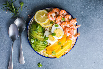 Buddha bowl with avocado, prawns, rice,  on light background. Healthy food, clean eating, Buddha bowl, top view,