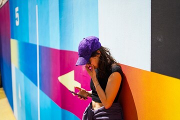 Young girl on coloured wall © evacasasx