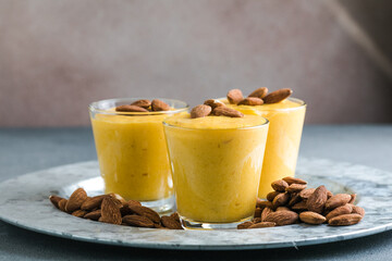 Authentic Indian cold drink made up of curd, milk malai called Lassi in saffron, kesar flavour, also called kesariya or keshariya or kesar lassi, served in  glasses