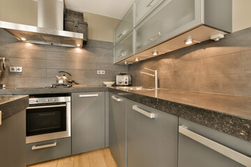 a modern kitchen with granite counter tops and stainless steel appliances on the wall behind it is...