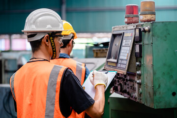 Engineers or Supervisors using a digital tablet and discussing inspection workshops mechanical maintenance in a factory, Working together, Coordination and Teamwork concepts.