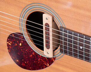cloise up shot of acoustic guitar sound hole pickup type . made by wood, selective focus © bjginny