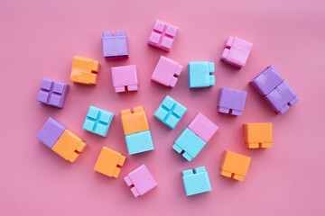 Plastic building blocks isolated on pink background. Top view