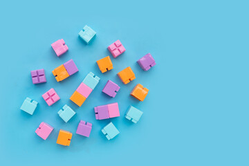 Plastic building blocks isolated on blue background. Top view