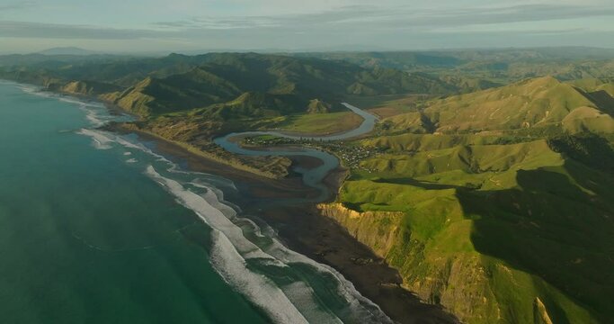 Marokopa coastal village on stunning coastline of New Zealand at golden hour
