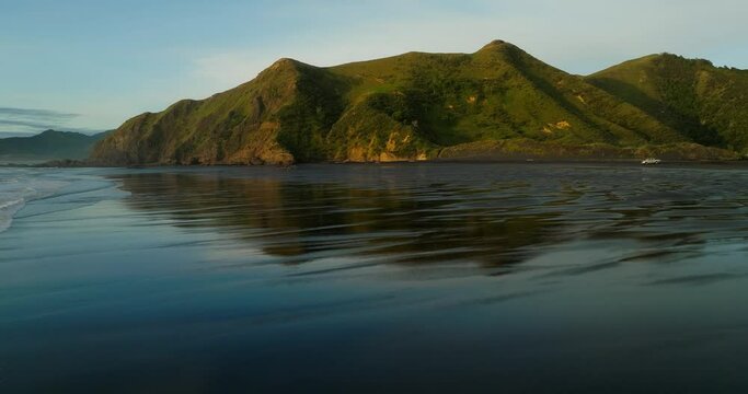 Low tide at Kiritehere Beach during golden hour sunset, aerial
