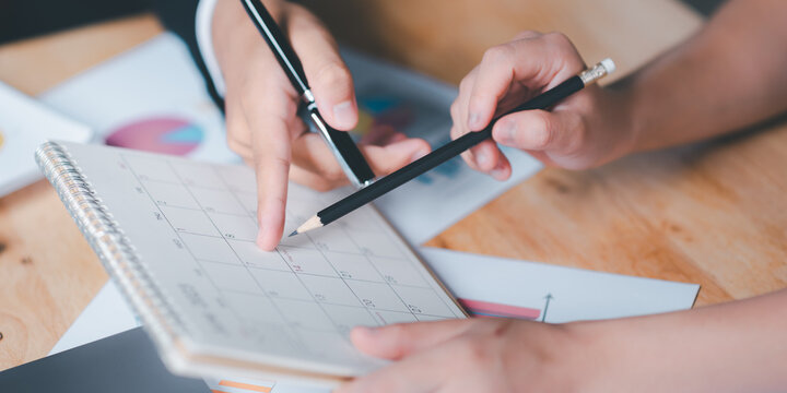 Strategic Planning Concepts, brainstorm ideas on business plans, Updating schedules or planning business, teamwork and data analysis, marketing development, This male hand at the calendar to schedule