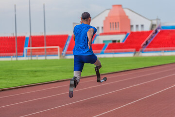 Fototapeta premium Back view of Asian male athlete with prosthetics sprints, aiming for record at speed running practice