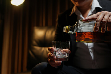 Closeup businessmen holding a glass of whiskey