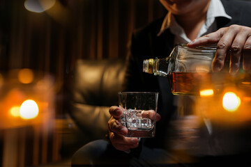 Closeup businessmen holding a glass of whiskey
