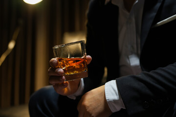 Closeup businessmen holding a glass of whiskey