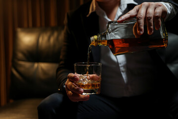 Closeup businessmen holding a glass of whiskey