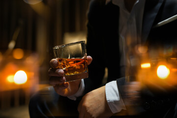 Closeup businessmen holding a glass of whiskey