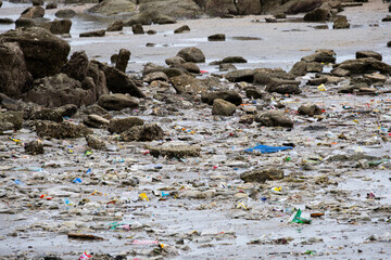 Obraz premium Beach debris, plastic cups and plastic bags. Marine debris is one of the world's major environmental problems.