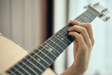 young male musician playing acoustic guitar , Close up classic guitar , finger style . happy mood white background with copy space can use for music school.