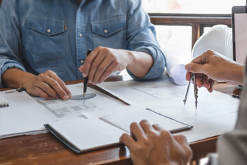 Architects interior designer hands working with Blue prints and documents for a home renovation for house design