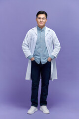 Handsome young man wearing doctor uniform with a happy and cool smile on face