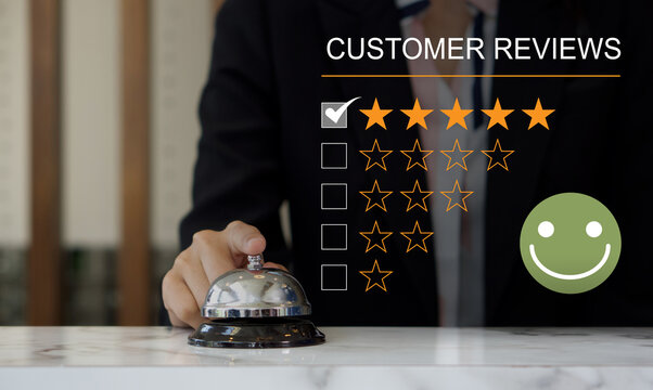 Customer experience satisfied concept, silver service bell on hotel reception desk with happy emotion face, great review, good service like good quality, high rating, social media very good.