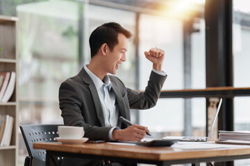 Happy asian business person employee celebrating while reading email good news. business account and finance