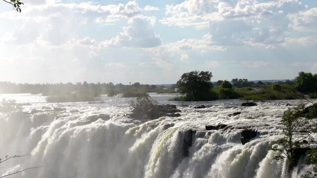 Slow motion shot of the amazing Victoria Falls on the Zambezi River at the border of Zambia and Zimbabwe.