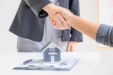 Real estate agents and buyers handshake after signing a business contract, renting, buying, mortgage, loan or home insurance