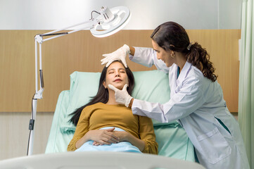 Female doctor or dermatologist  examining facial skin of young patient prepare before facelift...
