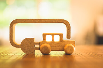 Wooden car with wires and lithium battery, Technology battery high power electric energy with a connected charging cable. Battery to electric cars and mobile devices with clean electric.	
