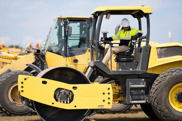 construction man worker at construction heavy machinery or roadwork machine equipment outdoor