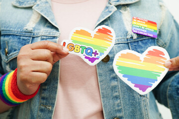 Asian woman with rainbow flag, LGBT symbol rights and gender equality, LGBT Pride Month in June.