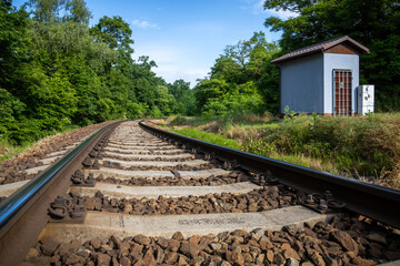 Railway in summer countryside under blue sky