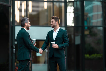 two business partners hold coffee dealing negotiation, copy space. photo of two business partners