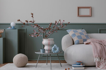 Interior design of cozy living room interior with mock up poster frame, boucle sofa, round coffee...