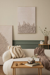 Spring composition of cozy living room interior with mock up poster frame, boucle sofa, patterned pillow, brown plaid, books, wooden coffee table and personal accessories. Home decor. Template.