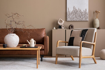 Interior design of cozy living room interior with mock up poster frame, brown sofa, gray armchair, wooden coffee table, beige carpet and personal accessories. Home decor. Template.